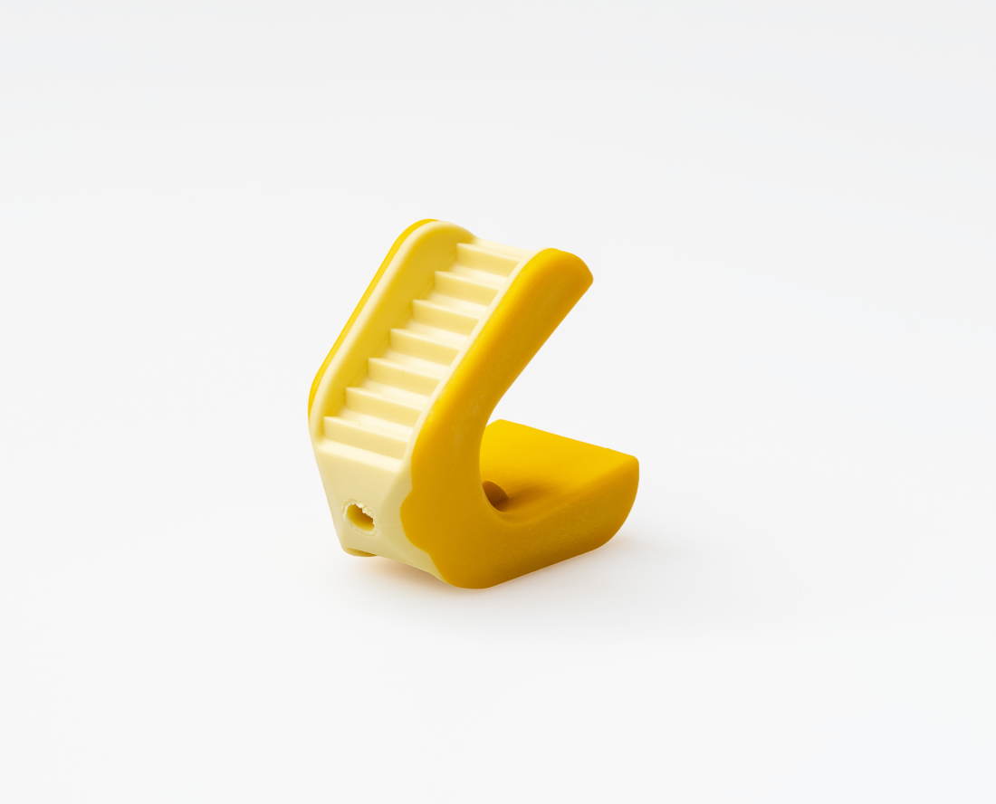 Yellow LogiBloc bite block on a white background